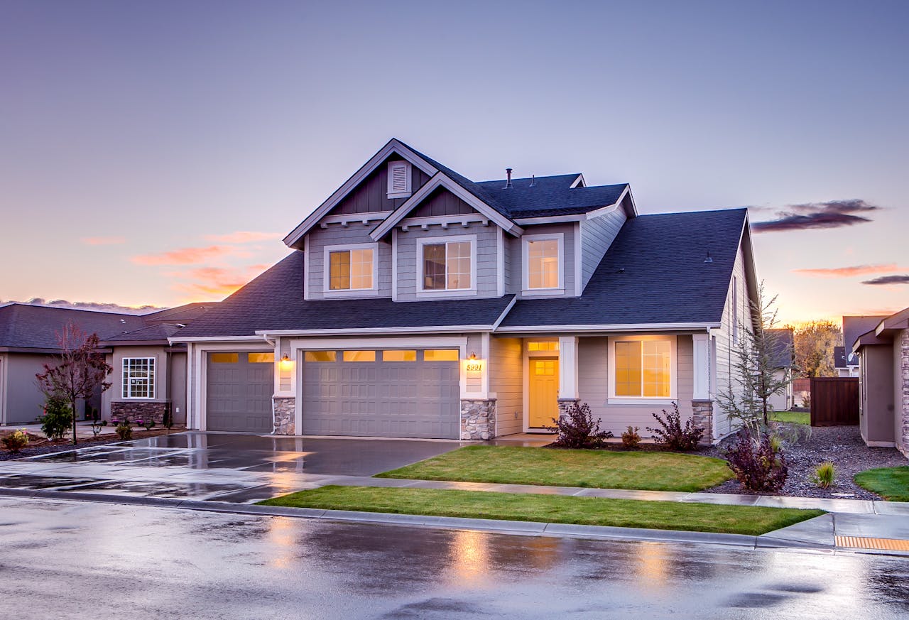 home-img Elegant suburban home with driveway at sunset showcasing modern architecture.